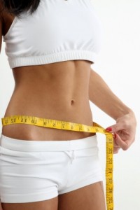 thin woman with lean and tight body measuring waist